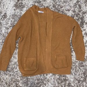 Neutral brown/orange colored cardigan.